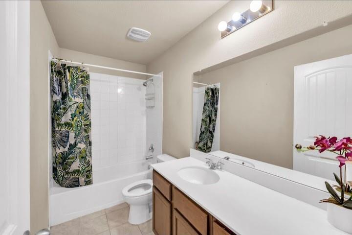 2315 Julia Lane Forney, TX 75126 - Photo 16 of 35 Full bathroom featuring shower / bath combination with curtain, vanity, and light tile patterned floors