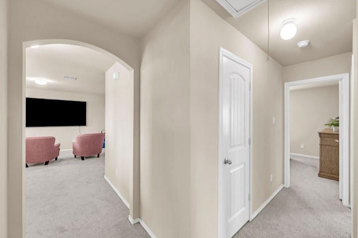 2315 Julia Lane Forney, TX 75126 - Photo 17 of 35 Hallway with light colored carpet and attic access