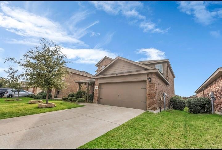 2315 Julia Lane Forney, TX 75126 - Photo 2 of 35 View of front of home with a front lawn, concrete driveway, brick siding, and a garage