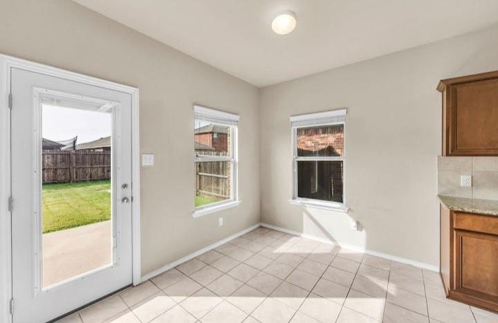 2315 Julia Lane Forney, TX 75126 - Photo 23 of 35 Unfurnished dining area featuring light tile patterned floors