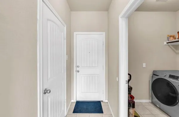 a view of a hallway with washer and dryer