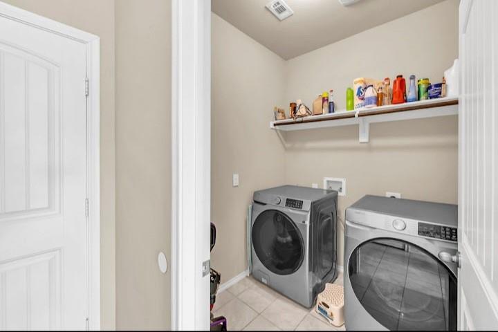 2315 Julia Lane Forney, TX 75126 - Photo 25 of 35 Washroom featuring light tile patterned floors and separate washer and dryer