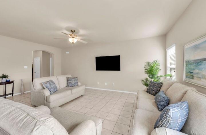 2315 Julia Lane Forney, TX 75126 - Photo 27 of 35 Living room with light tile patterned floors, arched walkways, and ceiling fan