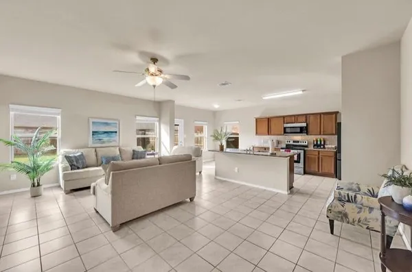 a living room with furniture and kitchen view