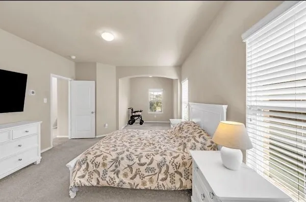 a bedroom with a bed and lamp