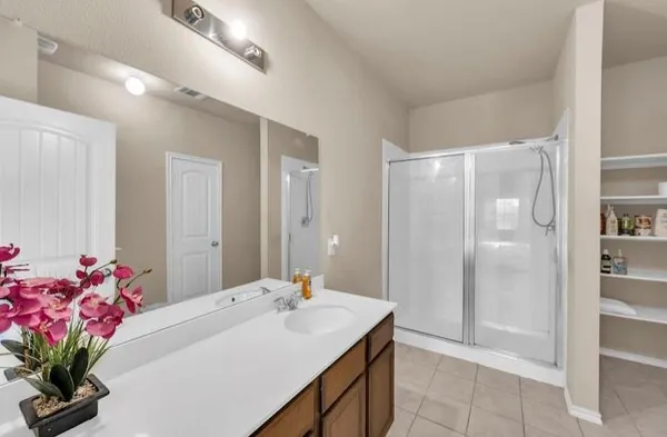 a bathroom with a sink vanity tub and shower