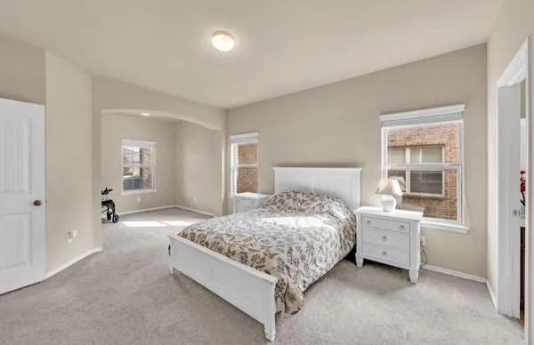 a bedroom with a bed and window