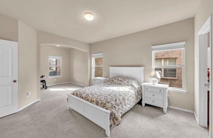 2315 Julia Lane Forney, TX 75126 - Photo 34 of 35 Carpeted bedroom featuring arched walkways and baseboards