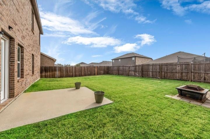 2315 Julia Lane Forney, TX 75126 - Photo 8 of 35 Fenced backyard with a patio and an outdoor fire pit