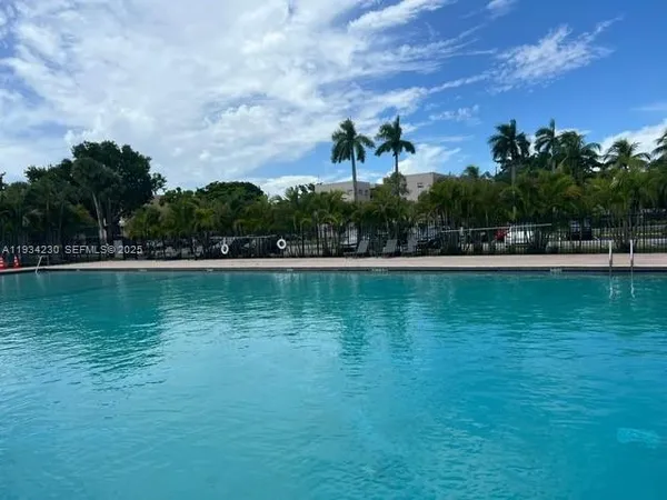 a view of a lake with houses in the background