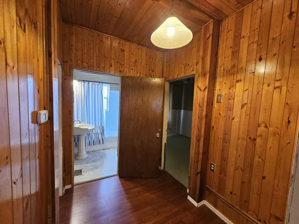 a view of a bathroom with a sink and wooden floor