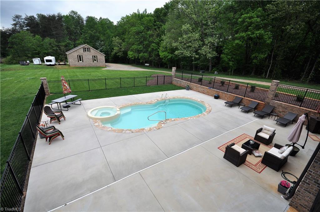 5849 Pepper Road Oak Ridge, NC 27310 - Photo 19 of 28 Summer is coming so enjoy the pool. Wait till winter and enjoy the hot tub