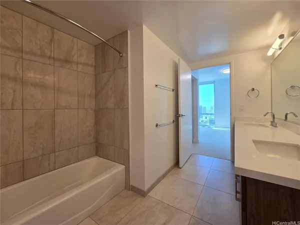 a bathroom with a bathtub a sink a vanity and a shower