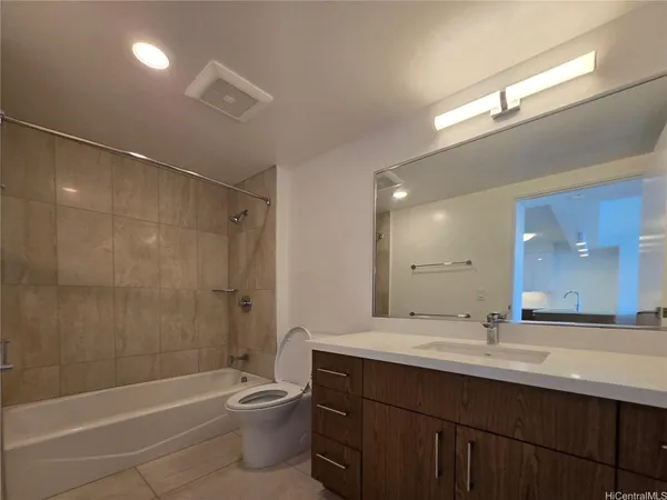 a bathroom with a double vanity sink toilet mirror and bathtub