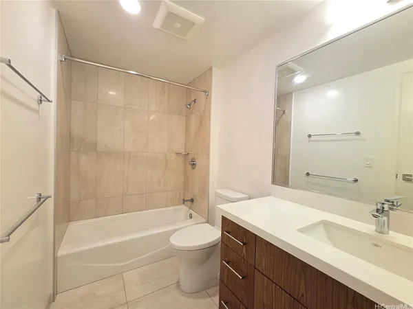 a bathroom with a sink a toilet a mirror and bathtub