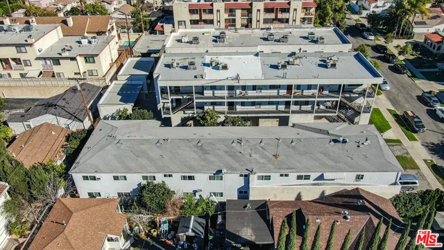 an aerial view of a house with a yard
