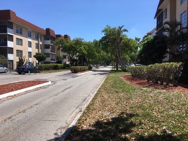 4154 Inverrary Drive, Unit 407 Lauderhill, FL 33319 - Photo 27 of 39 a view of a building with a yard