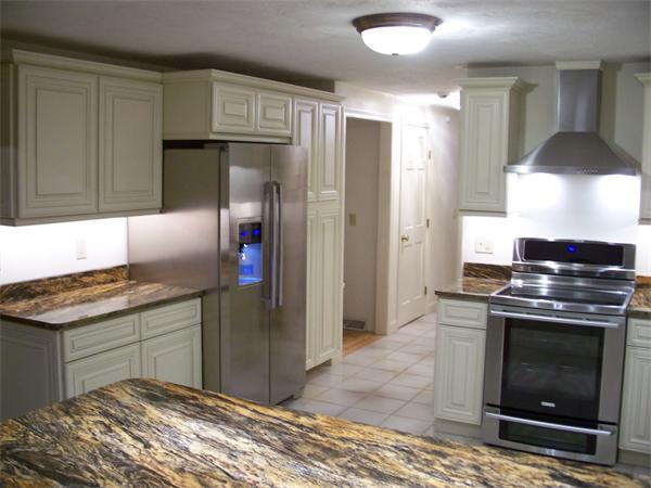 164 Kettle Hole Road Bolton, MA 01740 - Photo 5 of 28 a kitchen with granite countertop a stove and a refrigerator