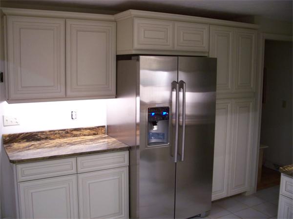164 Kettle Hole Road Bolton, MA 01740 - Photo 8 of 28 a kitchen with a refrigerator and cabinets