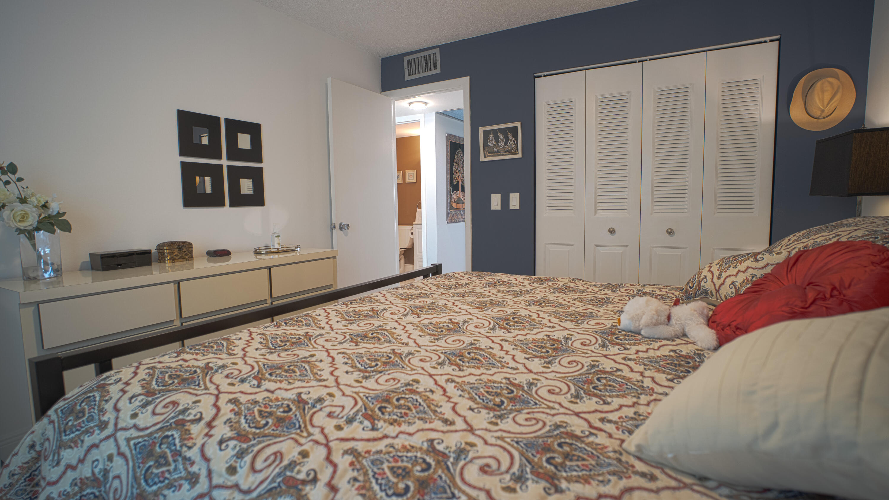 240 Windsor K West Palm Beach, FL 33417 - Photo 12 of 30 a bedroom with a large bed and closet