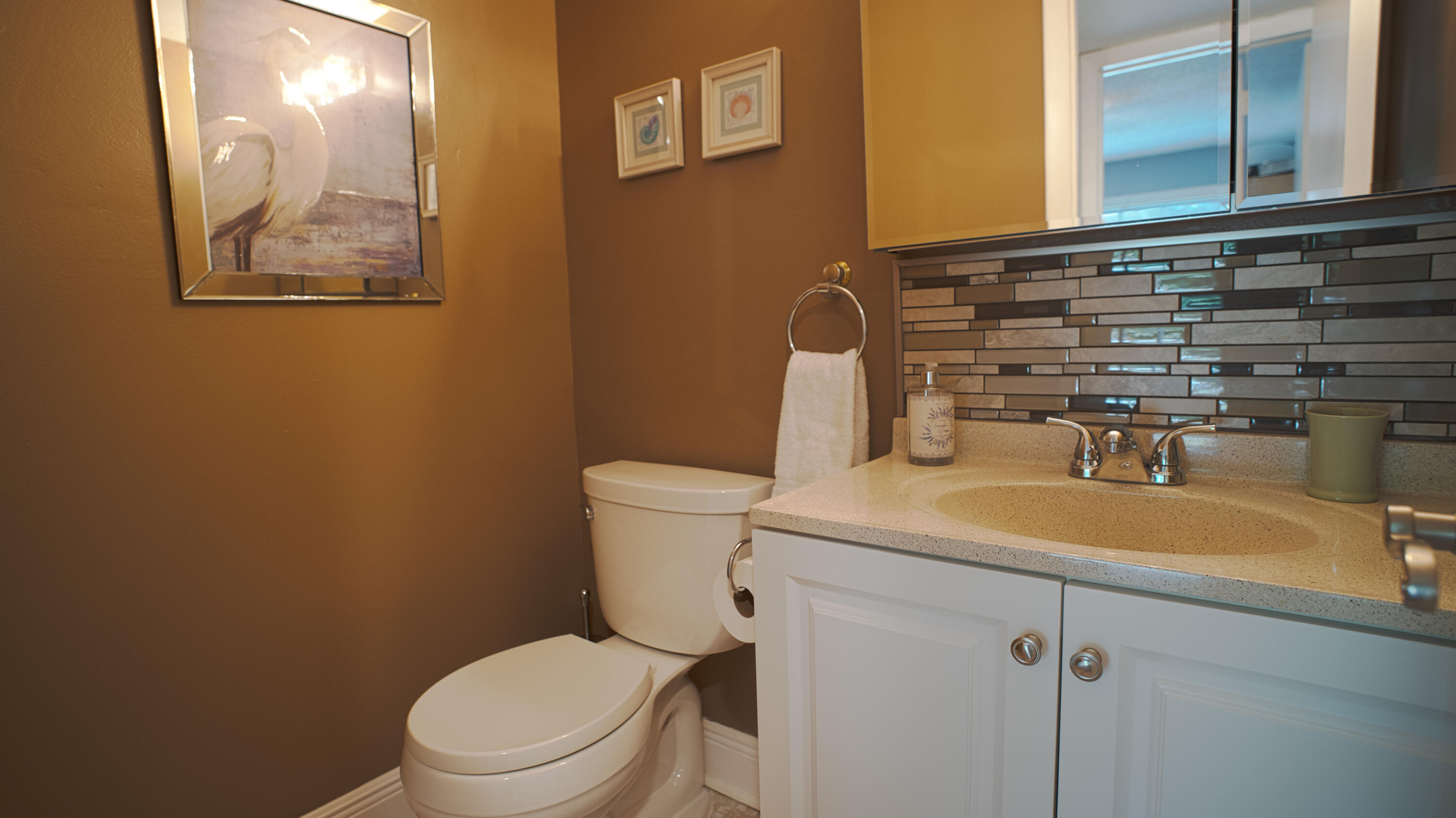 240 Windsor K West Palm Beach, FL 33417 - Photo 18 of 30 a bathroom with a toilet sink and mirror