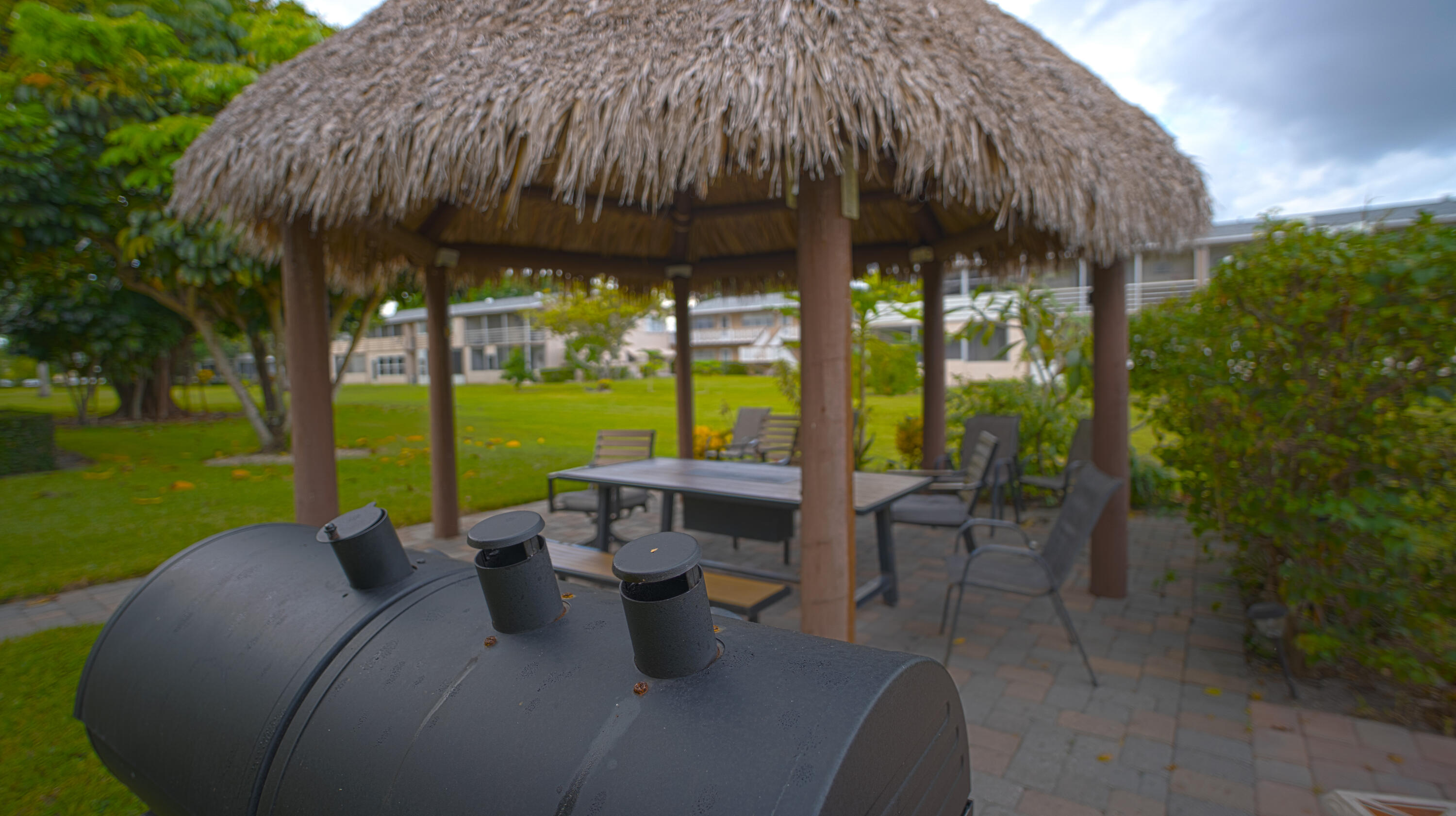 240 Windsor K West Palm Beach, FL 33417 - Photo 22 of 30 a view of an outdoor sitting area with a table and chairs
