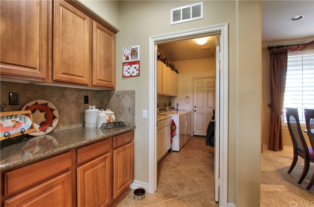 35107 Hogan Drive Beaumont, CA 92223 - Photo 11 of 42 a kitchen with refrigerator and window