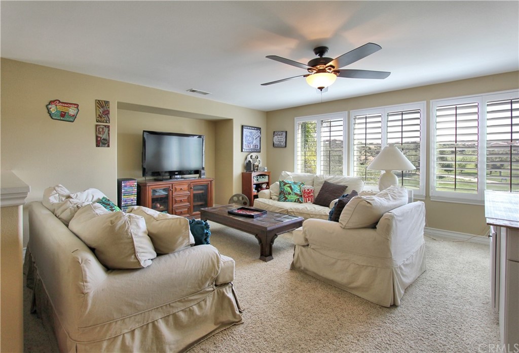 35107 Hogan Drive Beaumont, CA 92223 - Photo 19 of 42 a living room with furniture and a flat screen tv