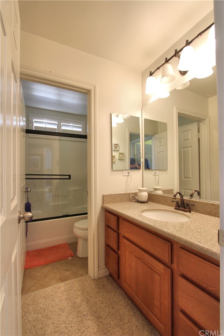 35107 Hogan Drive Beaumont, CA 92223 - Photo 21 of 42 a bathroom with a granite countertop sink mirror and toilet
