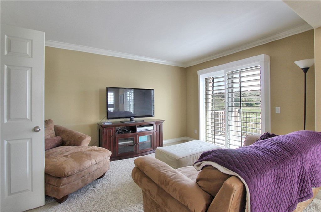 35107 Hogan Drive Beaumont, CA 92223 - Photo 24 of 42 a bedroom with a bed and a couch with window