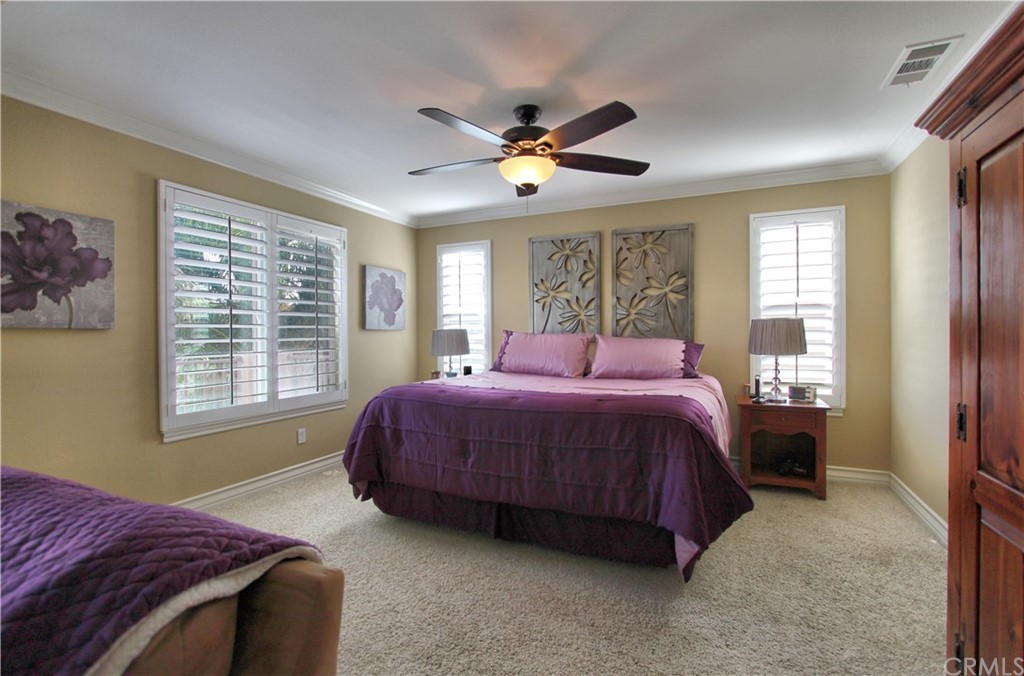 35107 Hogan Drive Beaumont, CA 92223 - Photo 25 of 42 a bedroom with a bed and a chandelier