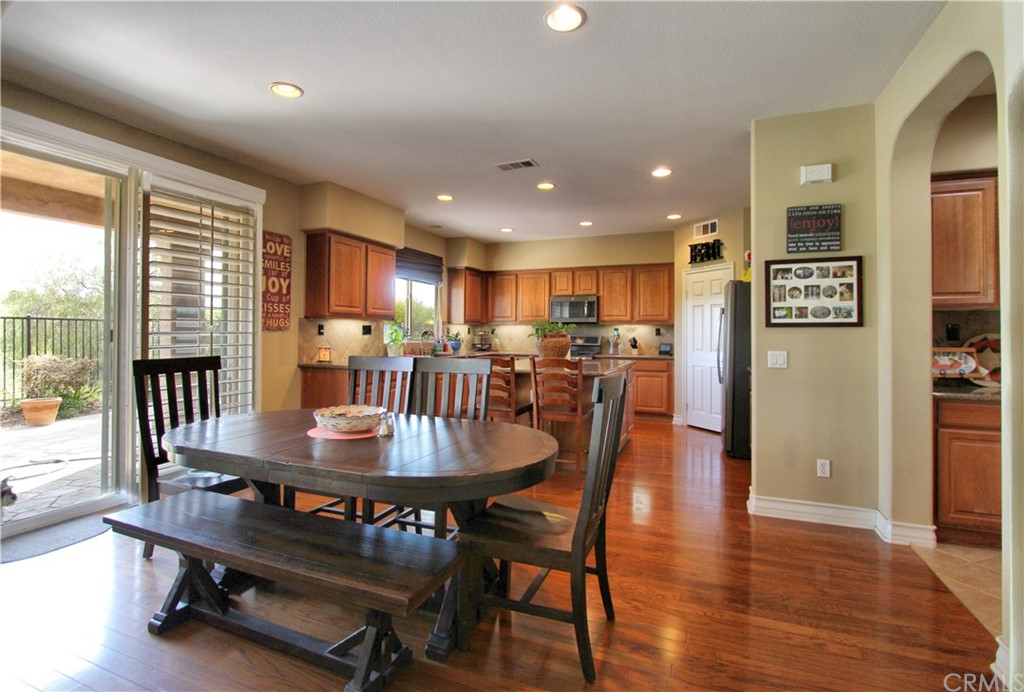 35107 Hogan Drive Beaumont, CA 92223 - Photo 7 of 42 a view of a dining room with furniture window and wooden floor