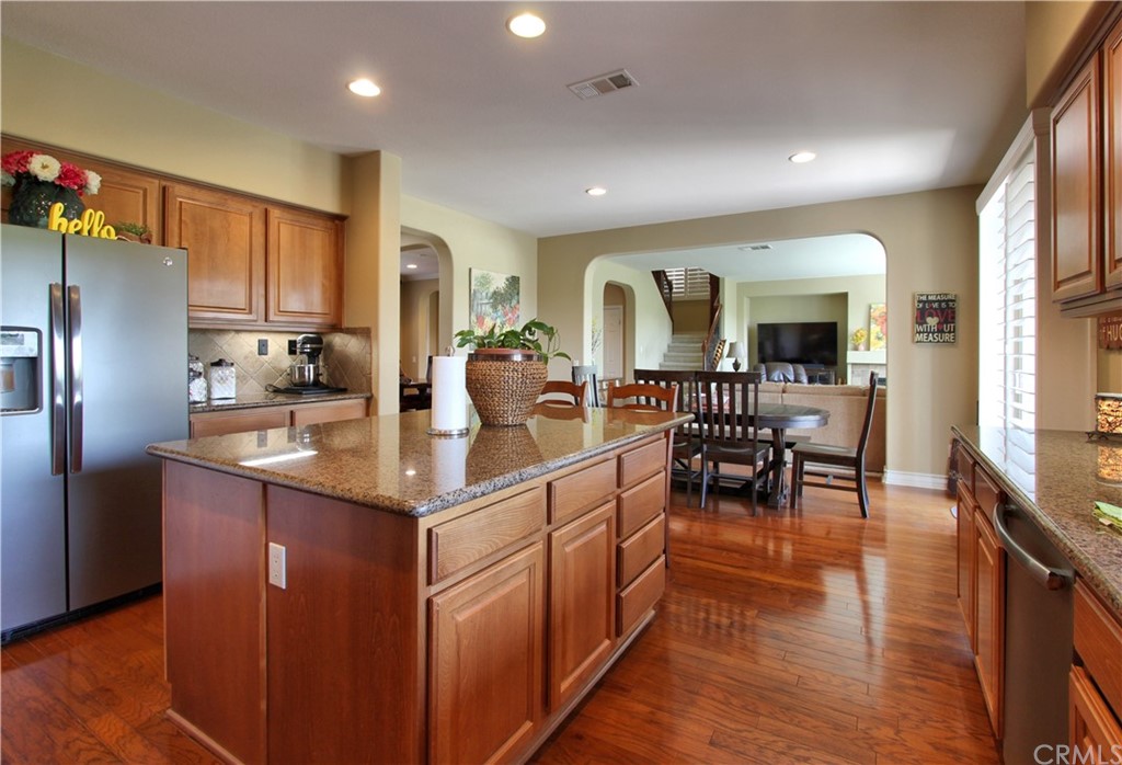 35107 Hogan Drive Beaumont, CA 92223 - Photo 10 of 42 a kitchen with stainless steel appliances granite countertop table chairs and a refrigerator