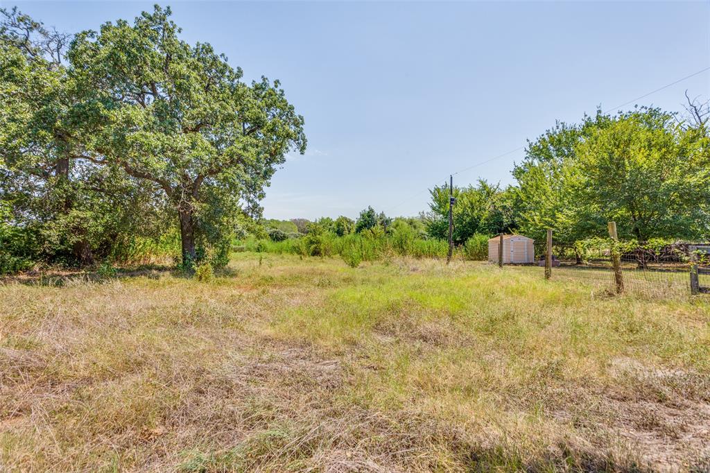7329 Drury Cross Road Burleson, TX 76028 - Photo 2 of 13 View of yard with a storage unit