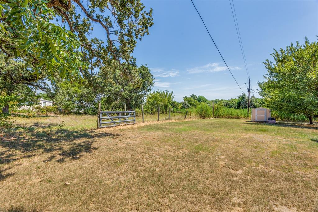 7329 Drury Cross Road Burleson, TX 76028 - Photo 4 of 13 View of yard with a rural view and a storage shed