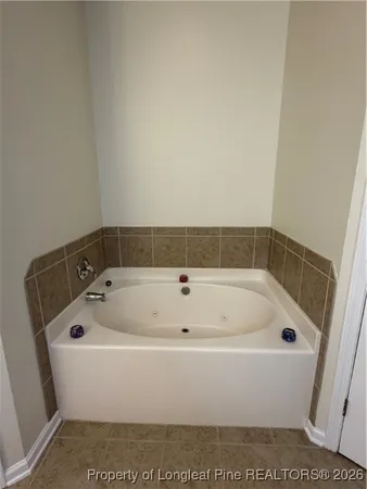 a white bath tub sitting in a bathroom