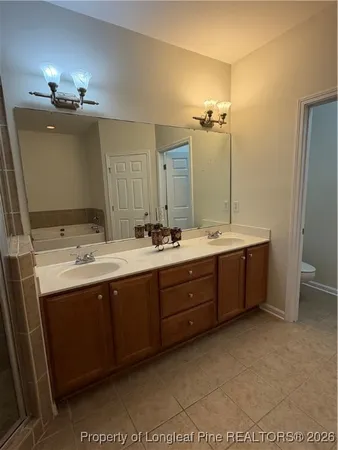 a bathroom with double vanity sink a vanity and a mirror