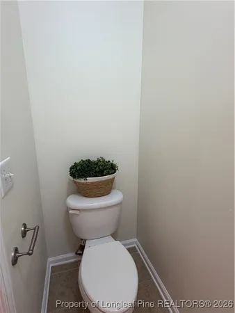a white toilet sitting next to a shower
