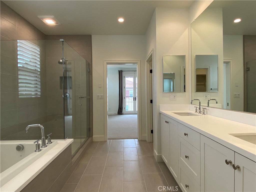 120 Spotted Quail Irvine, CA 92618 - Photo 18 of 32 a spacious bathroom with a double vanity sink mirror and shower
