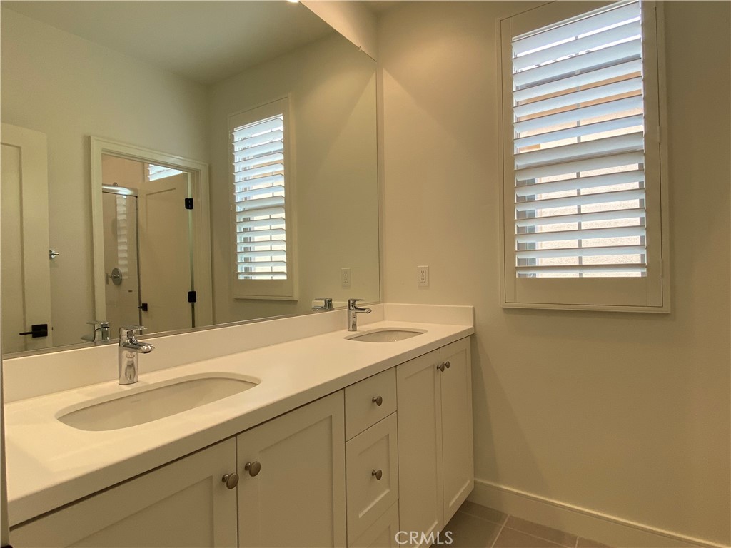 120 Spotted Quail Irvine, CA 92618 - Photo 21 of 32 a bathroom with a sink and a mirror