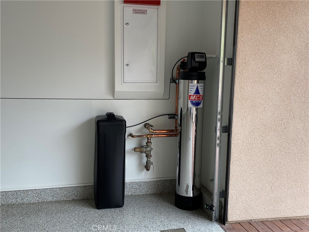 120 Spotted Quail Irvine, CA 92618 - Photo 25 of 32 a utility room with water heater and white walls