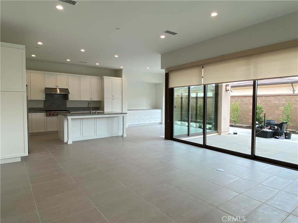 120 Spotted Quail Irvine, CA 92618 - Photo 3 of 32 a large white kitchen with a large window and stainless steel appliances
