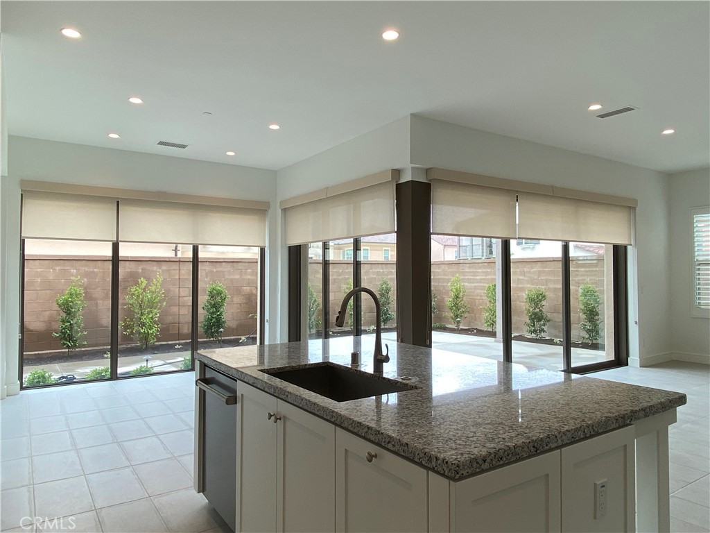 120 Spotted Quail Irvine, CA 92618 - Photo 6 of 32 a kitchen with granite countertop a sink and a counter top space