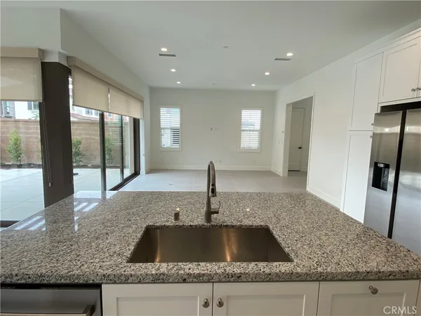 a kitchen with granite countertop a sink and a large window