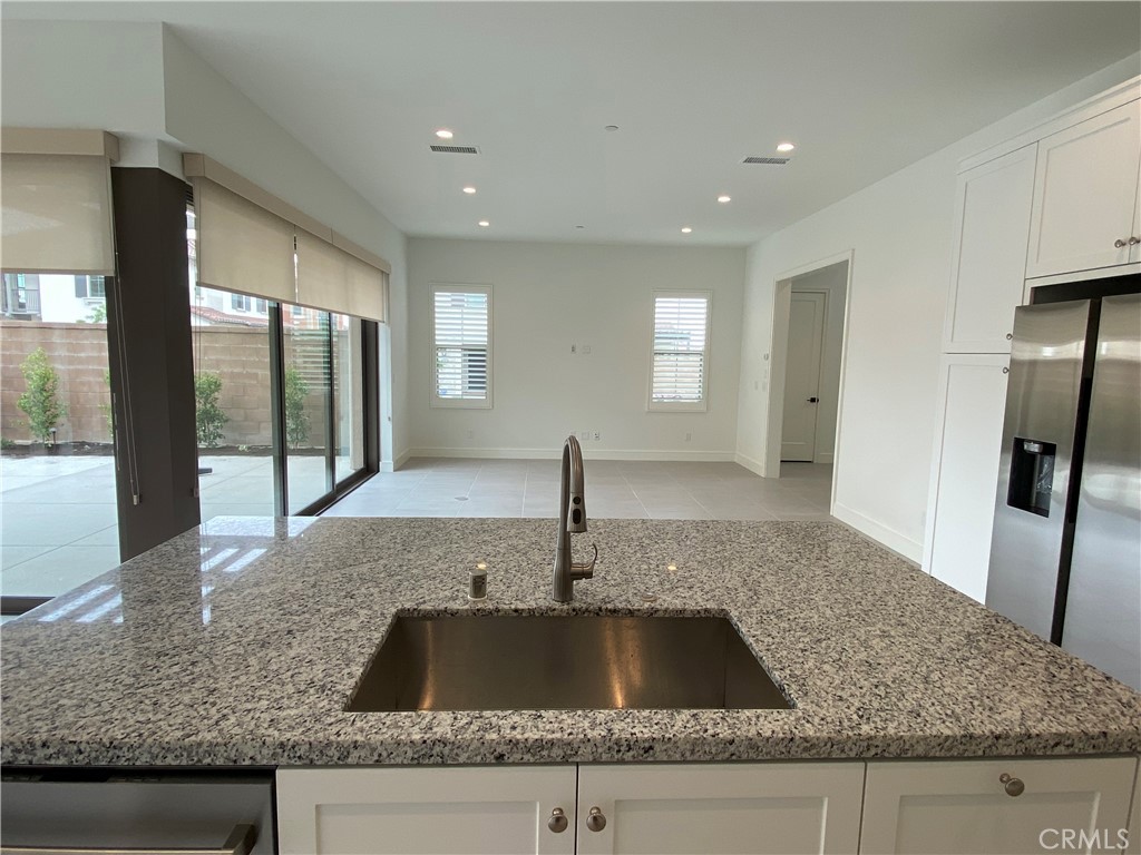 120 Spotted Quail Irvine, CA 92618 - Photo 8 of 32 a kitchen with granite countertop a sink and a large window