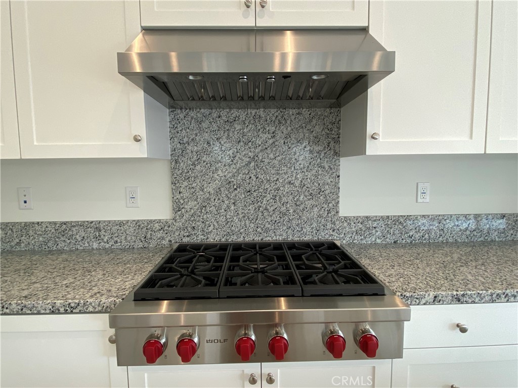 120 Spotted Quail Irvine, CA 92618 - Photo 9 of 32 a kitchen with a stove and cabinets
