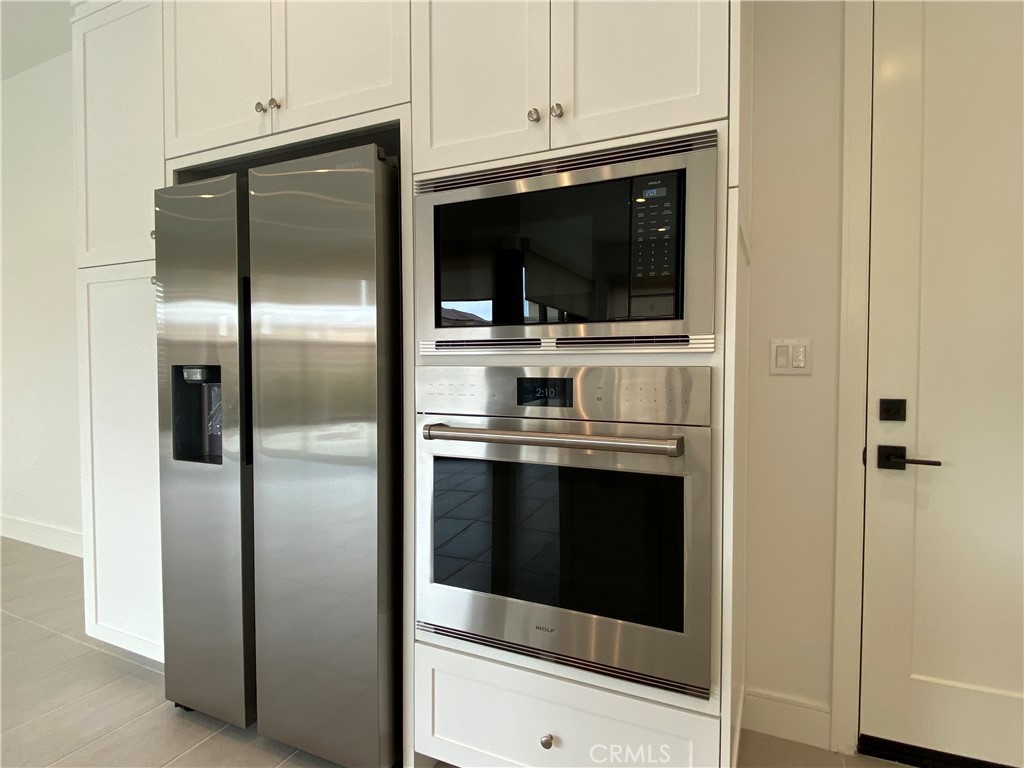120 Spotted Quail Irvine, CA 92618 - Photo 10 of 32 a kitchen with stainless steel appliances and cabinets