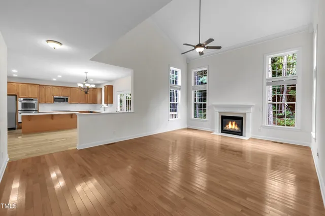wooden floor fireplace and windows in an empty room