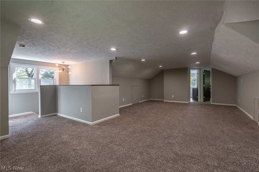1393 Clearview Road Cleveland, OH 44124 - Photo 19 of 35 Open and expansive, this 18x30 second level room is open to create your own living environment. There is ample storage in the eaves. This view highlights the master bathroom and walk in closet.