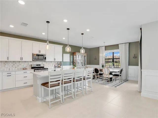 a kitchen with appliances a sink and cabinets